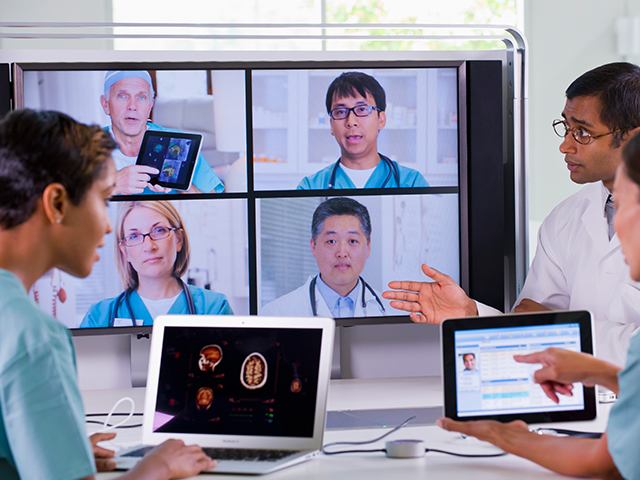 medical professionals having a meeting over digital conferencing technology